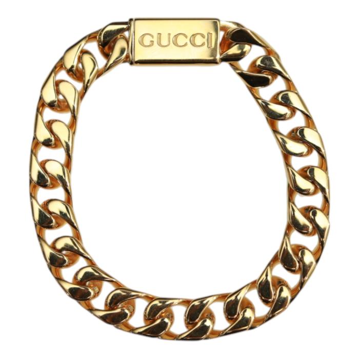 GUCCI Script logo-engraved gold-tone metal thick chain bracelet retails at 550$